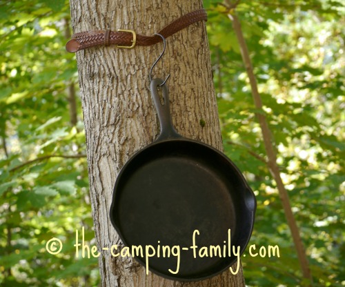 cast iron pan hung on tree