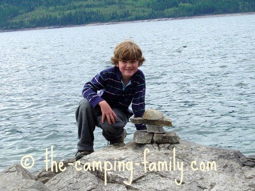 boy with stone inukshuk