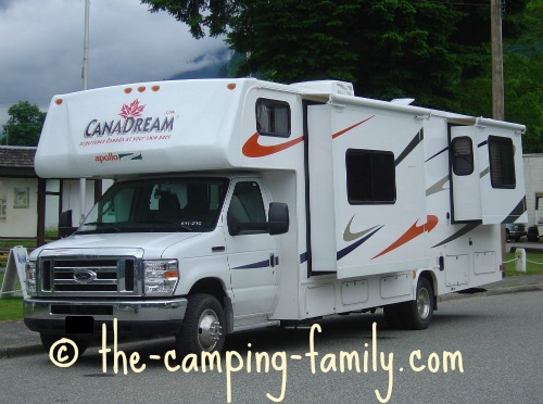 motorhome with slide-outs parked on road