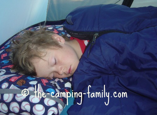 boy in synthetic sleeping bag